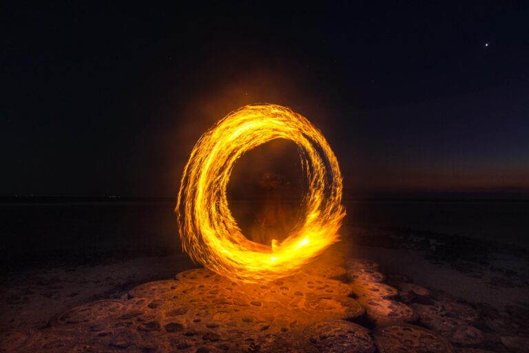 person performing fire dance at night