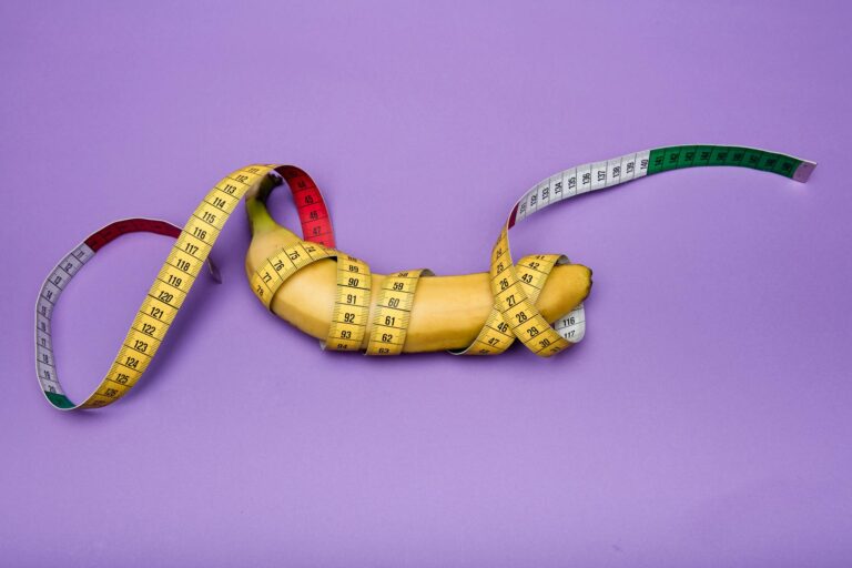 yellow banana and measuring tape on purple background